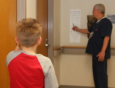 A young boy taking an eye exam.