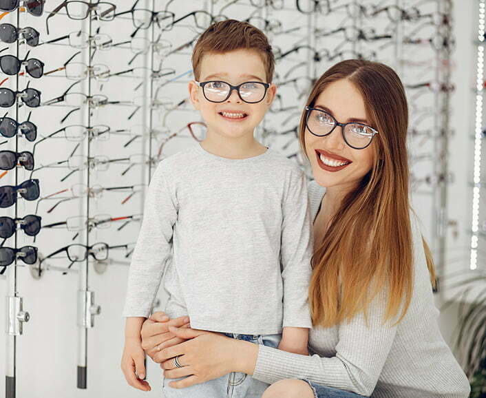Mother with little son in the glasses store