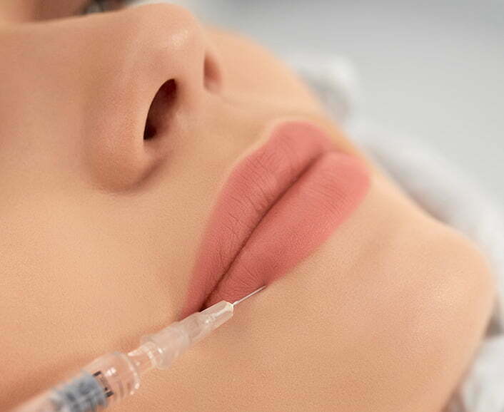 Procedure lip augmentation in professional salon.